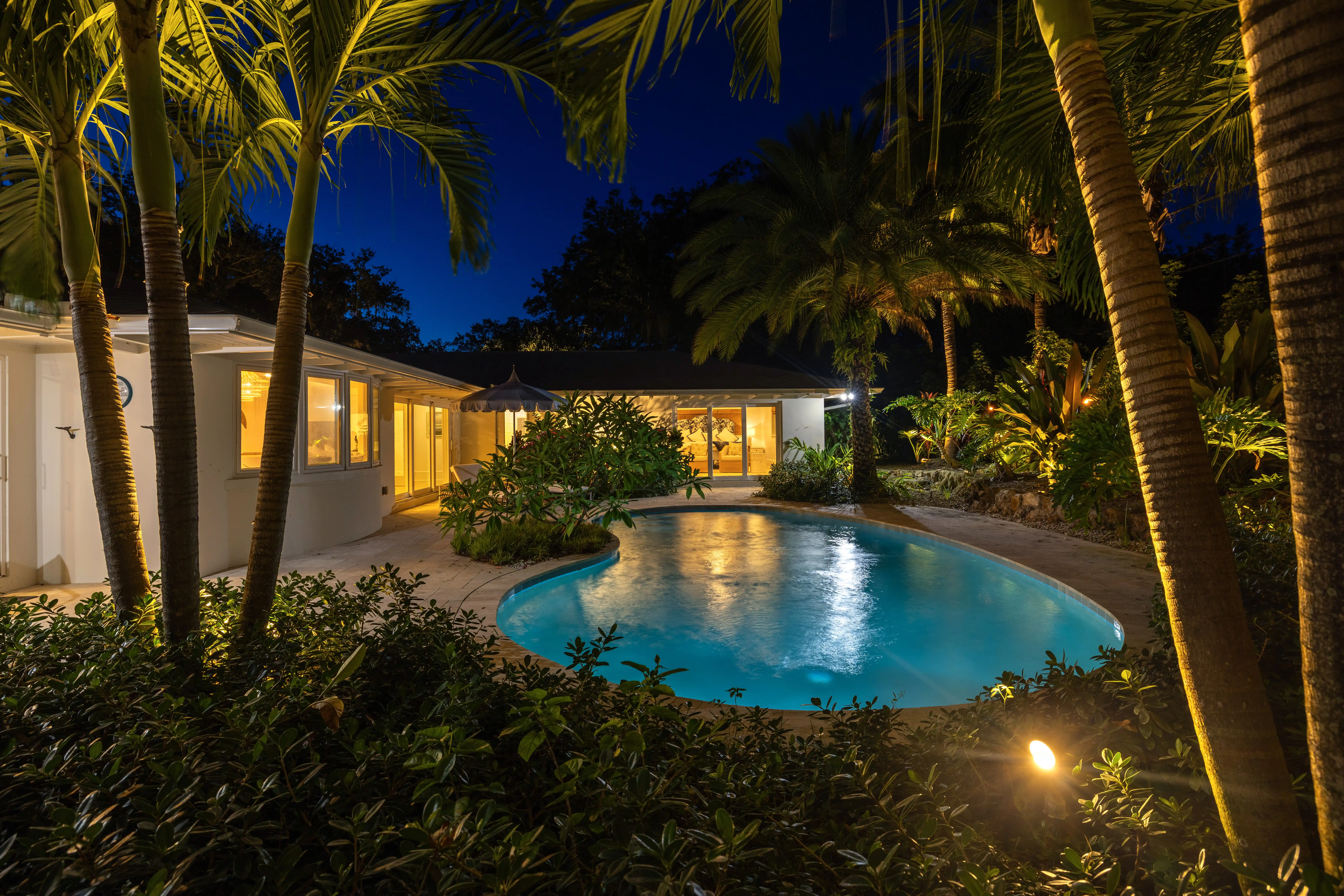 House with a swimming pool at night photograph by seaside imagery the real estate photographer in Port St. Lucie