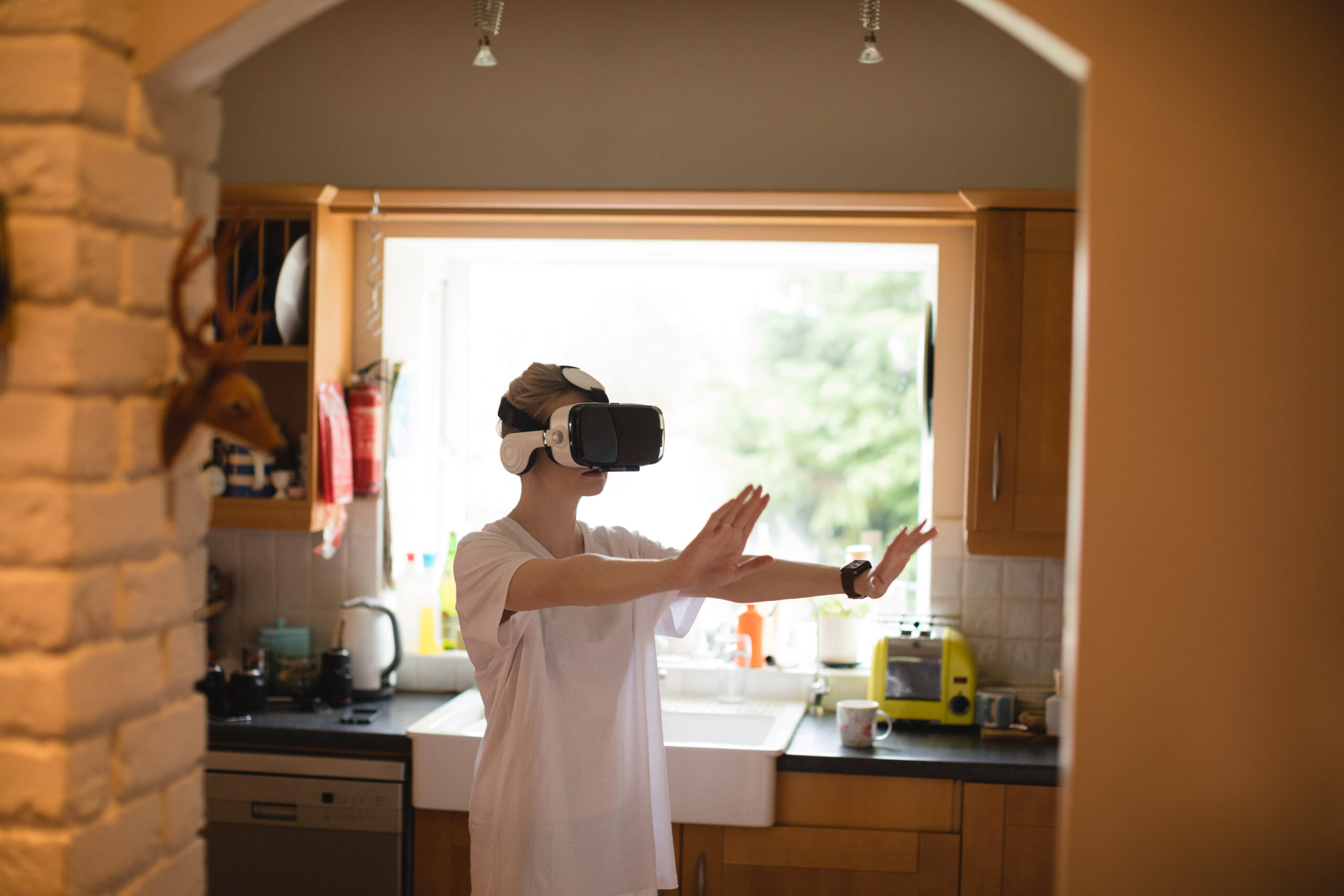 real estate photographer take a picture of a woman gesturing using virtual reality